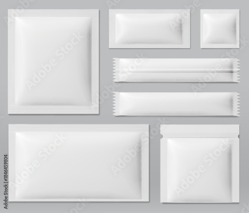 Sachet mockup set with blank white foil pouches in various sizes on gray background. Realistic 3D package templates for cosmetic masks, food products, powder and stick packs with sealed edges.