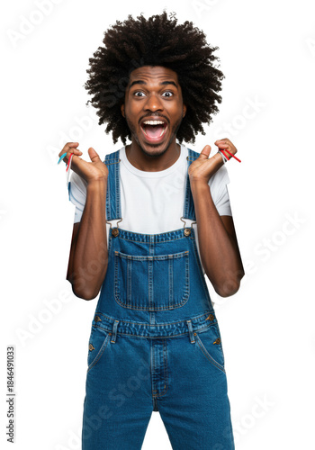 Young African American man, afro, white tee, blue overalls, joyfully clutching vivid shopping bags, smiling wide on transparent studio background. Consumerism and retail excitement