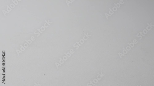 Picking up red sunglasses from a white table on a bright afternoon