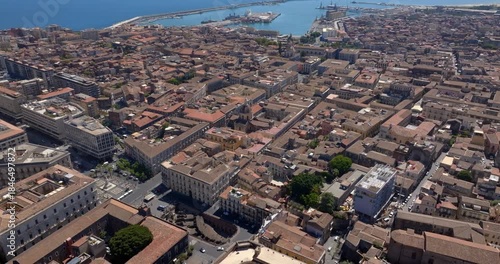 Aerial view of the city of Catania, Italy. It is the second largest city in Sicily. In foreground it is Stesicoro Square in the city center. The Mediterranean Sea and city port are in the background.