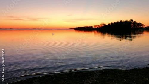 Beauty in nature. Sunset landscape with water sea, islands, Calm weather. Orange dusk sky. High quality 4K.