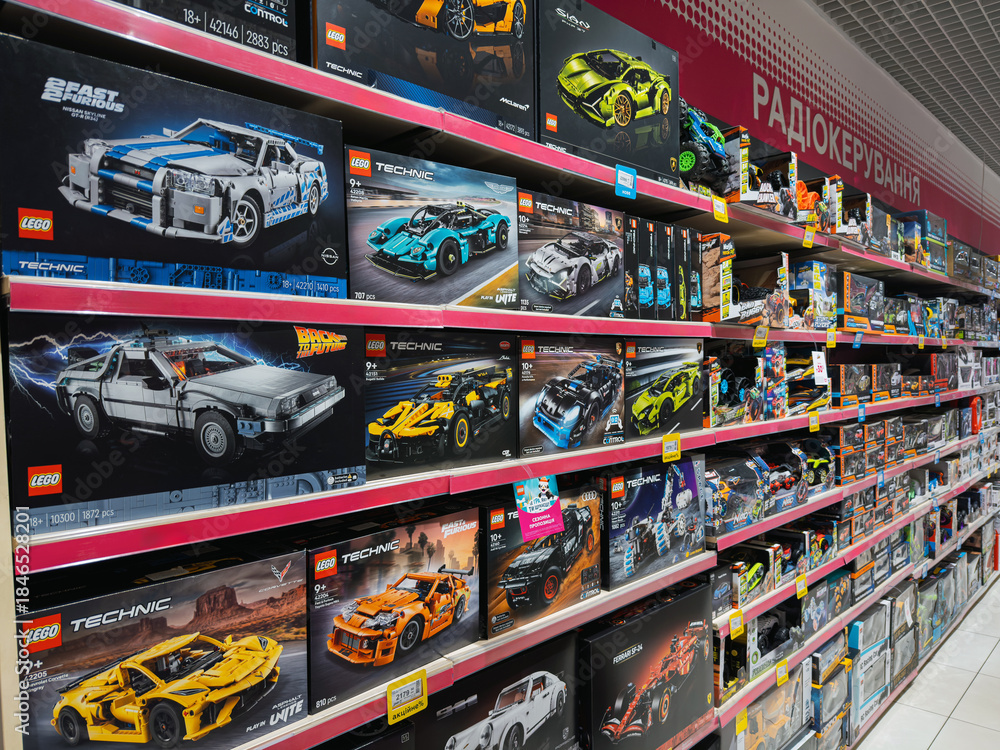 Obraz premium Dnipro, Ukraine 11.13.2025: Lego cars. Various LEGO construction sets and kits are displayed on shelves at a toy store. This demonstrates the brand's popularity and presence in retail.