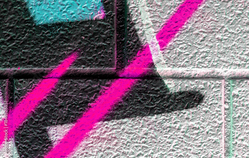 vivid street graffiti texture of colotful spray painting strips on gray metallic brick background, urban culture of modern youth backdrop