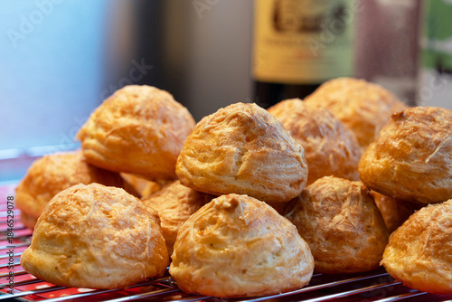 Close up of traditional French cheese puff or Gougères in a baking tray. It's a traditional pastry made with savory choux dough. The pastry  know as typically of Burgundy region take as an appetizer. 