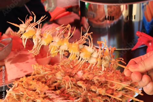 Close-up of Crispy Deep-Fried Mini Crabs on Skewers, Korean Street Food