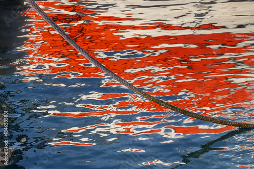 Rope and reflection of a boat in the sea, Greece