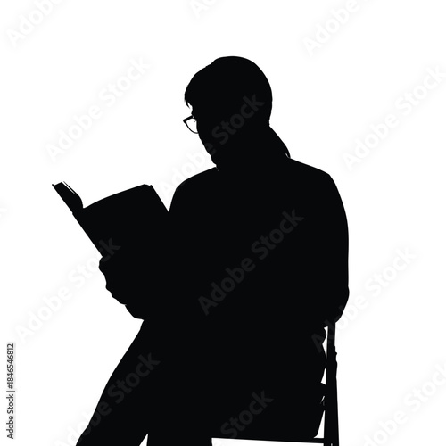 Silhouette of a person reading a book