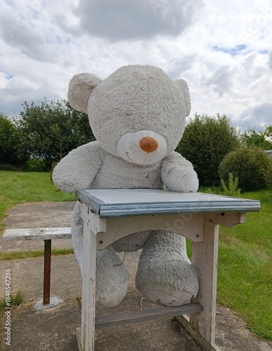 an abandoned large white teddy bear
