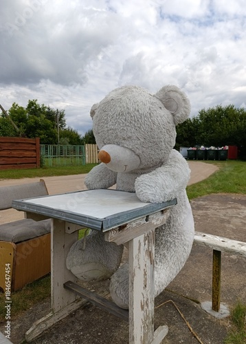 an abandoned large white teddy bear