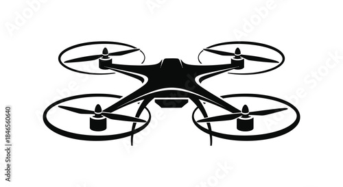 A sleek black quadcopter drone design with four rotors captured as a dramatic silhouette