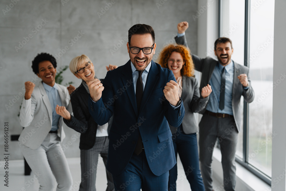 © Novak - A diverse team of successful professionals smiling and making positive hand gestures in a modern office. Concept of victory, great teamwork, and corporate success. © Novak - A diverse team of successful professionals smiling and making positive hand gestures in a modern office. Concept of victory, great teamwork, and corporate success.