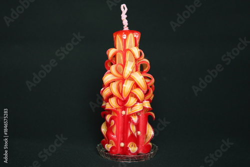 Photos Handcrafted carved candle made from layered red and yellow wax
