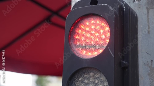 A close view of a traffic light changing signals, focusing on regulated movement, control systems, and the structured order that guides everyday urban life. Traffic control.