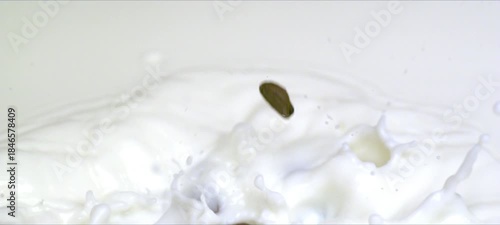 Wallpaper Mural Slow-motion coffee beans falling into milk, creamy splash and swirl Torontodigital.ca