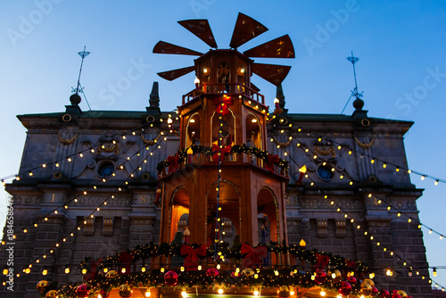 Wallpaper Mural A festive structure stands decorated with lights and ornaments. The scene shows a lively market at dusk with the holiday spirit. Christmas market in Gdansk, Poland Torontodigital.ca