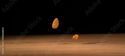 Wallpaper Mural Super slow-motion of almonds fall on wooden table. Healthy snack, satisfying crunch. Torontodigital.ca