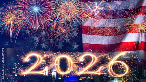 American flag waving with fireworks over city at night. Fireworks display on New Year's Eve to welcome the New Year.