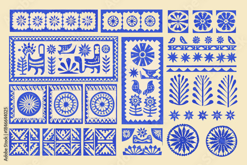 A collection of intricately cut blue and white paper folk art designs