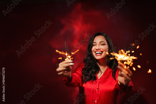  successful business woman celebrating, isolated on red light background with copy space.
