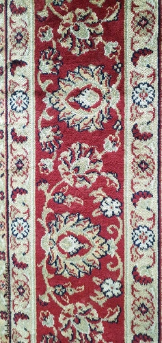 Carpet texture with a floral pattern in the antique baroque style. Floral abstract pattern carpet classic, red floral background, red carpet print. Interior design, home decor.