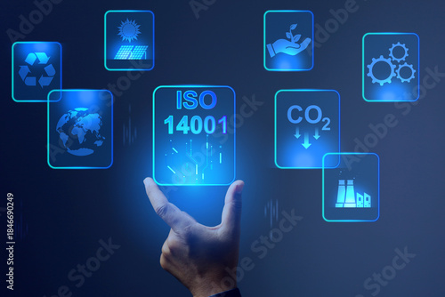 ISO 14001 concept with hand rising virtual screen for environment management system represent to reducing environmental impact and improving efficiency enhancing business and gaining advantage