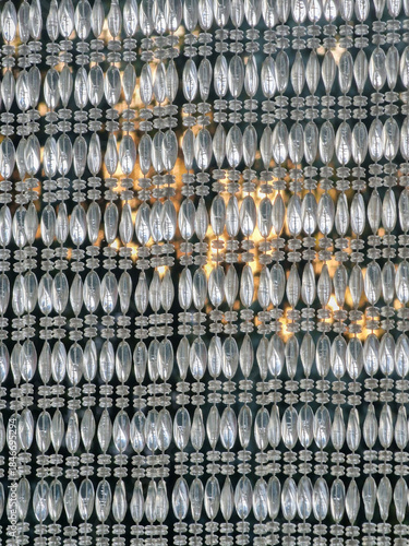 Close-up of a patio curtain decorated with numerous shiny glass beads