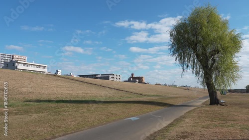 Empty riverside path under a vast blue sky concept of exercise and health