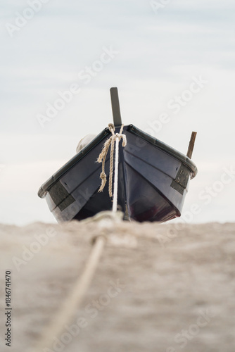 relaxing beach scene with boat by the sea