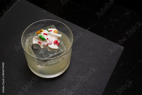 A refreshing cocktail in a glass with a special topping, perfect for any occasion!