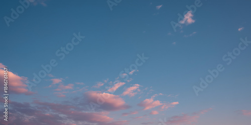 Sky with clouds during sunset with hues of pink and blue in evening light