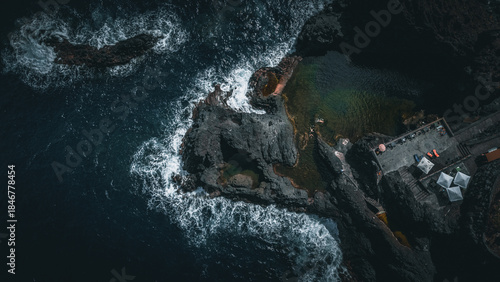 Aerial top‑down view of the rugged volcanic coastline and natural lava rock pools at Seixal on the island of Madeira, Portugal