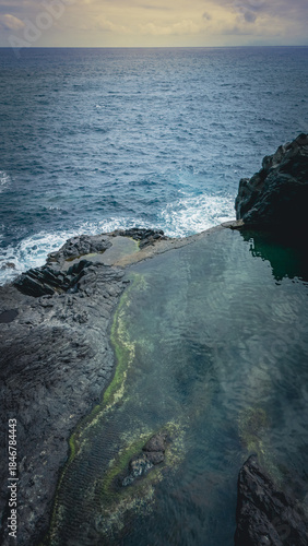 Aerial top‑down view of the rugged volcanic coastline and natural lava rock pools at Seixal on the island of Madeira, Portugal