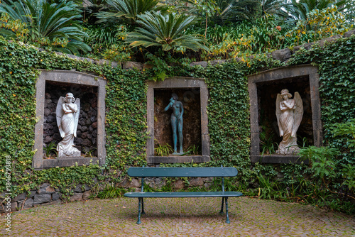 Tableau sur toile Three statue niches set in ivy and volcanic rock in Jardim Monte Palace, Funchal, Madeira