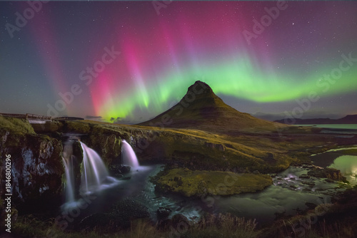Beautiful pink and green northern lights at Kirjufellfoss in Iceland 