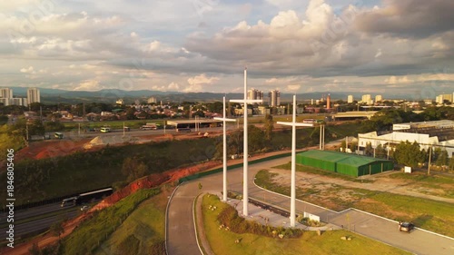 aerial view of three crux near a church and a highway in Sao Jose dos Campos during sunset