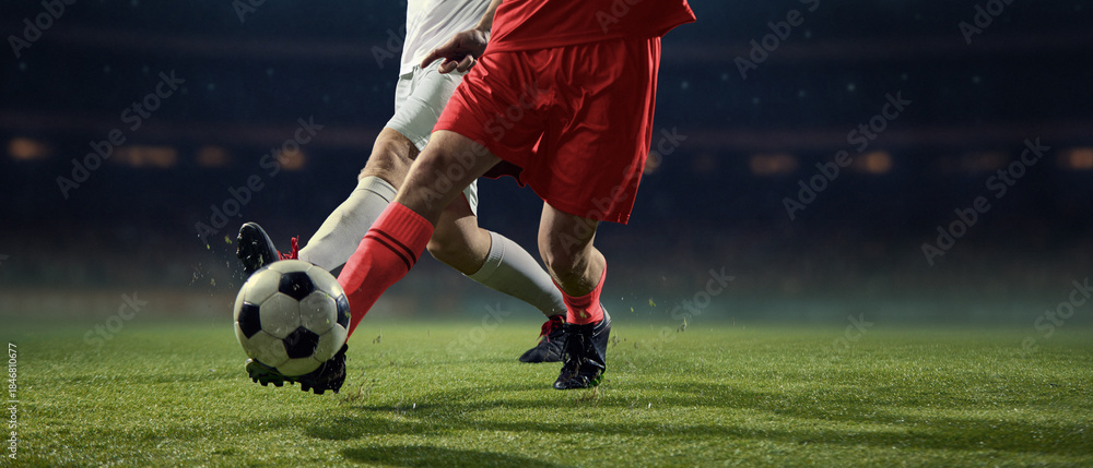 Naklejka premium Aggressive football challenge between rival players near ball. Concept of high-stakes competition, struggle for victory, professional athleticism, competitive tension, match intensity.