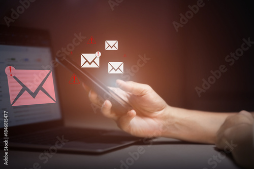 person typing on laptop receives scam notification, illustrating cybersecurity risk and data breach threat, Spam mail pop-up warning. E-mail inbox with spam virus message, Trash and junk mail, scam.