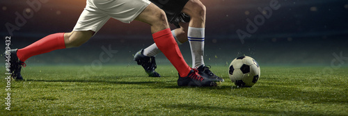 Fotografi Physical football clash as rival players challenge for ball on pitch