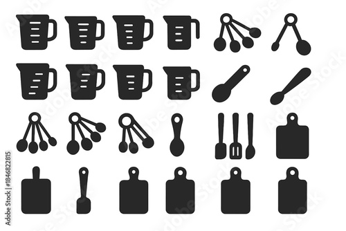 Kitchen tools and measuring utensils arranged on a white background for cooking and baking activities