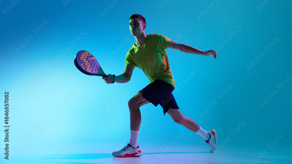 Fototapeta premium Padel athlete ready stance neon hybrid lighting. Concept of landing page sections, sports brand product pages, UI illustrations, interactive modules and structured digital design systems.