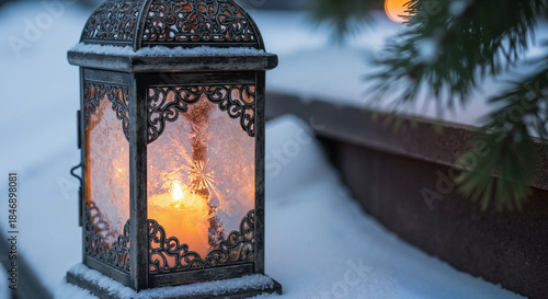 Ornate lantern glowing with candlelight on snow-covered ground  