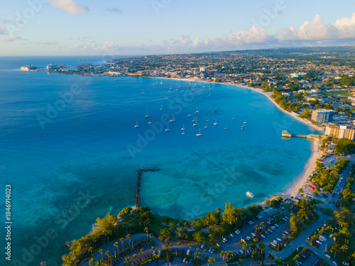 Pebbles Beach aerial view at sunset at Carlisle Bay in city of Bridgetown, Saint Michael, Barbados. This coast belongs to Bridgetown and Garrison UNESCO World Heritage Site. 