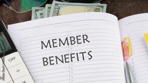 Member Benefits, e-commerce conceptual. Animation of the conceptual text of MEMBER BENEFITS in an open business notebook on a blank sheet