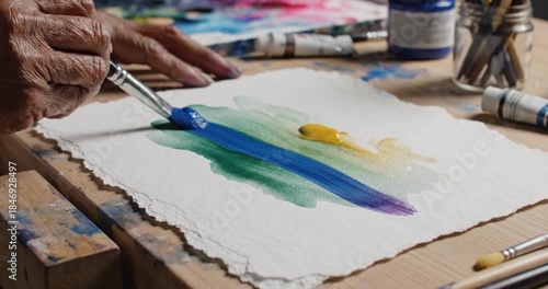 Artists Hands Painting Abstract Colors on Paper with Brush.