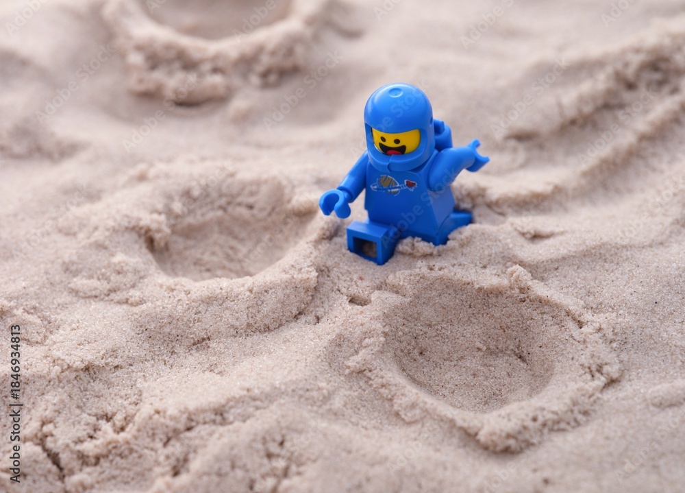 Obraz premium Tambov, Russian Federation - July 28, 2024 Lego Benny astronaut minifigure walking on sand on a planet
