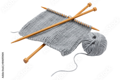 Grey knitted wool fabric with wooden needles and yarn ball isolated on a transparent background