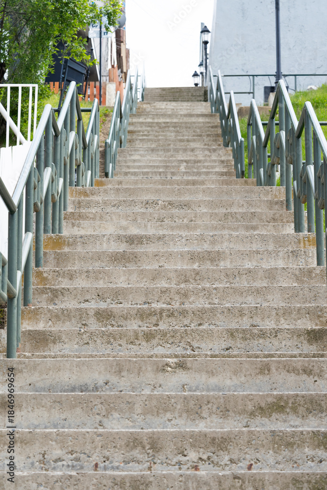 Φωτογραφία Long, Wide Outdoor Concrete Staircase with Metal Railings Leading Up to the Sky