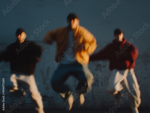 Three male dancers performing an energetic synchronized street dance jump with motion blur, expressing movement, freedom, and hip hop culture outdoors in an urban setting