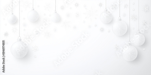 Silver Christmas ornaments hanging against a soft white background, with copy space for design