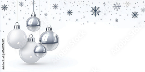 Silver Christmas ornaments hanging against a soft white background, with copy space for design